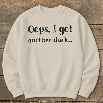 Cream sweatshirt with black text that reads "Oops, I got another duck..."