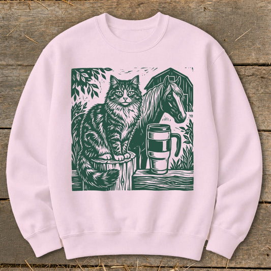 Cat and horse linocut design on a pink sweatshirt with a barn background.