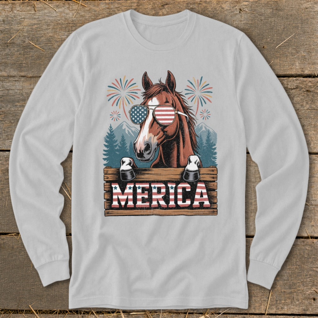 Horse wearing American flag sunglasses behind wooden sign with "MERICA" text.