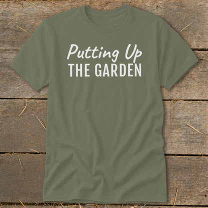 Olive green t-shirt with white text "Putting Up THE GARDEN".