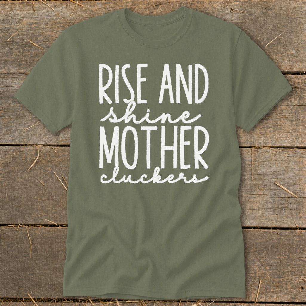 Olive green t-shirt with white text "RISE AND shine MOTHER cluckers".