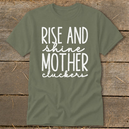 Olive green t-shirt with white text "RISE AND shine MOTHER cluckers".
