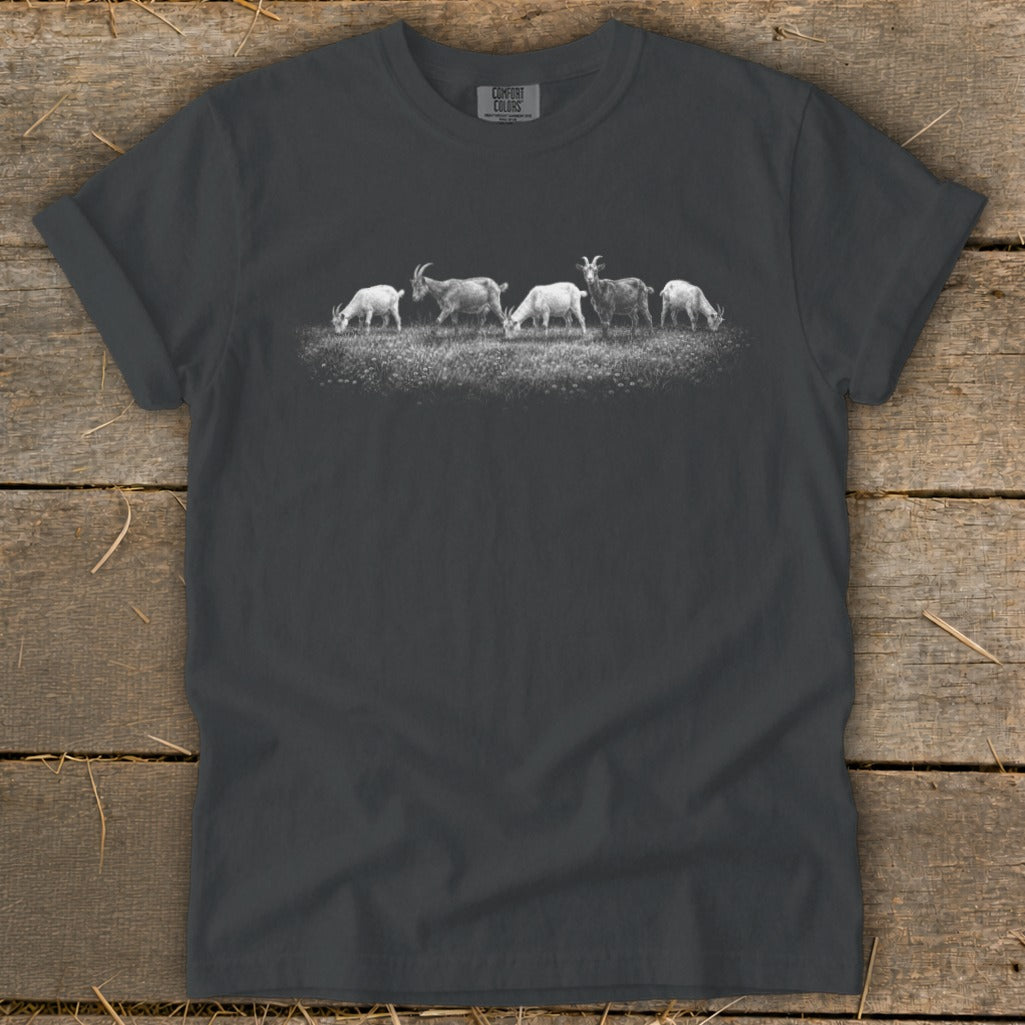Graphic of five goats grazing in a field on a charcoal t-shirt.