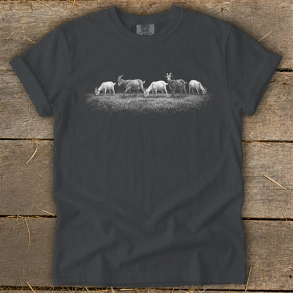 Graphic of five goats grazing in a field on a charcoal t-shirt.
