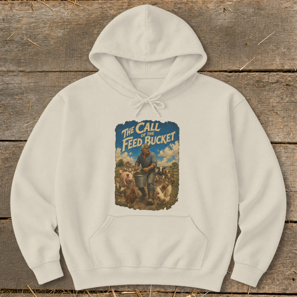 Cream hoodie with graphic of farmer feeding pigs and chickens, text "The Call of the Feed Bucket".