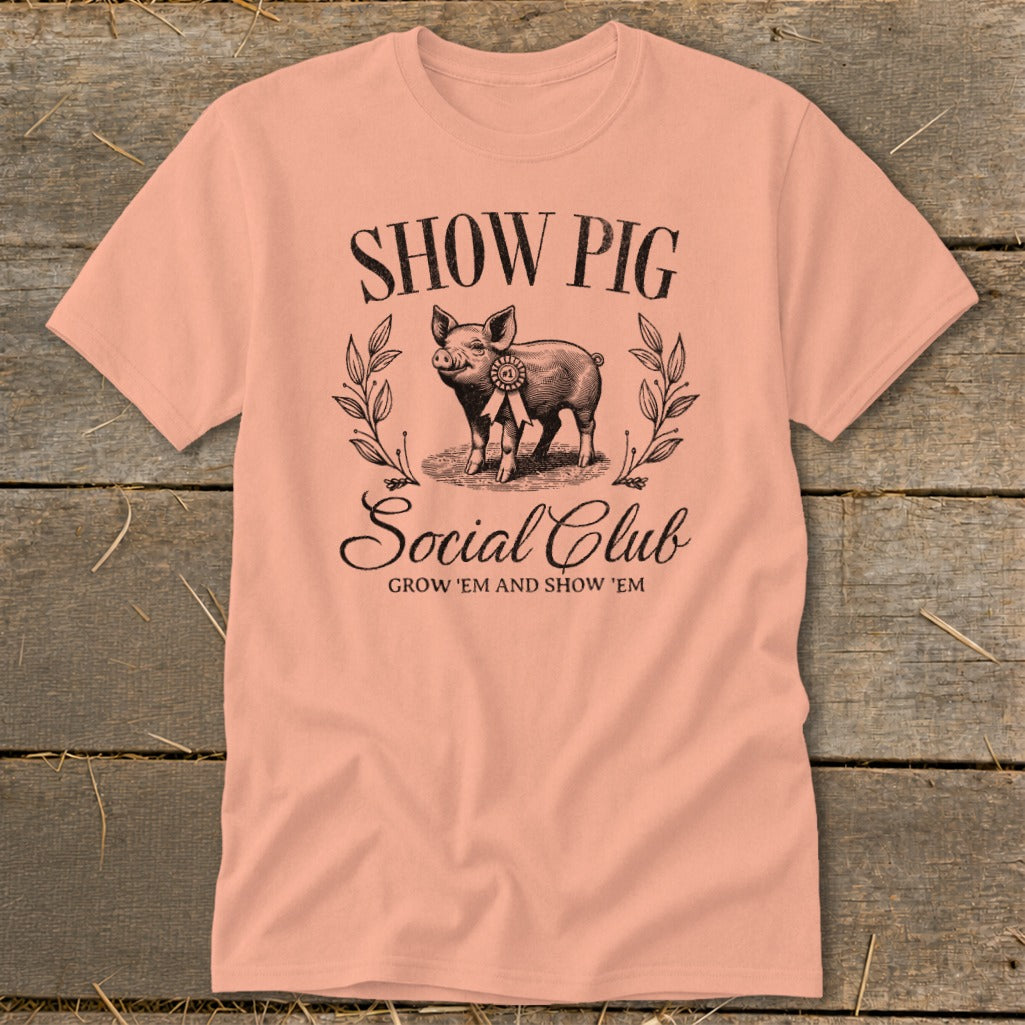 Peach t-shirt with a vintage pig illustration and "Show Pig Social Club" text.