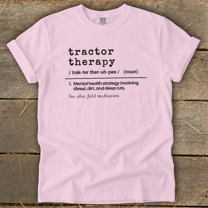 Pink t-shirt with "tractor therapy" definition and "field meditation" reference.
