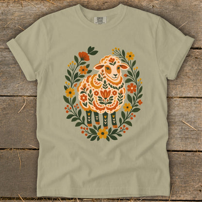 Folk art style sheep with floral wreath on a tan t-shirt.