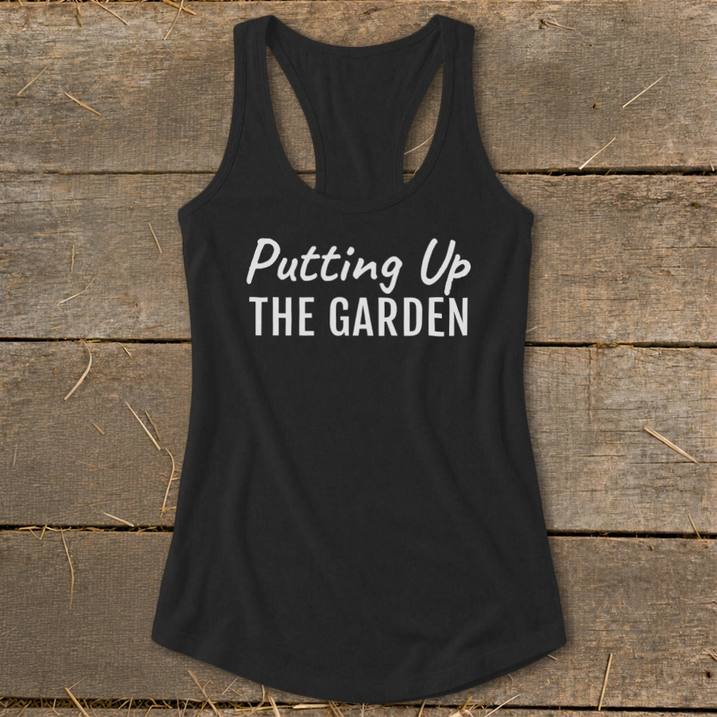 Black racerback tank top with white text "Putting Up THE GARDEN".