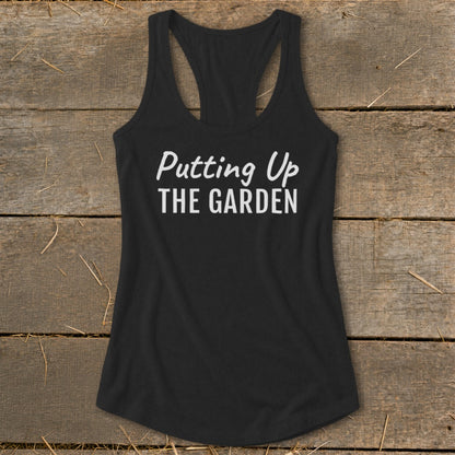 Black racerback tank top with white text "Putting Up THE GARDEN".