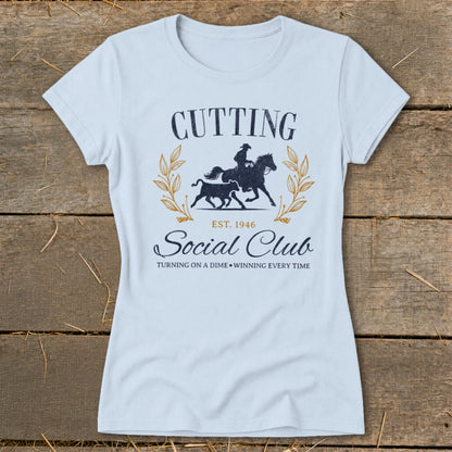 Light blue t-shirt with "Cutting Social Club" and equestrian graphic.