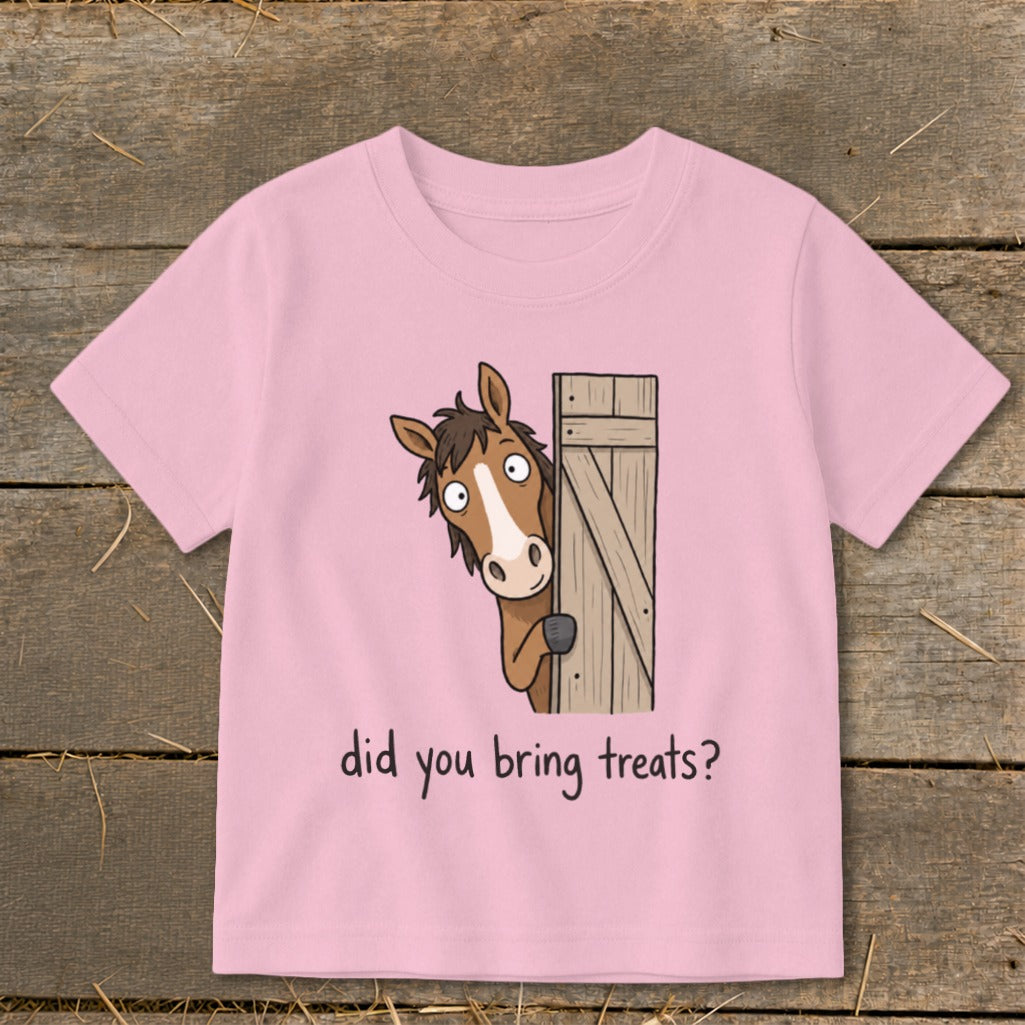 Pink t-shirt with cartoon horse peeking from behind a gate asking, "did you bring treats?"