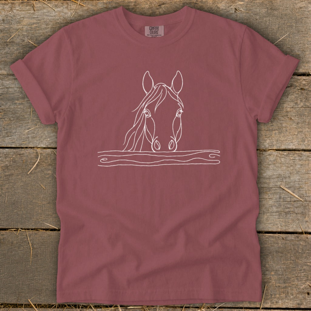 Maroon t-shirt with a white line drawing of a horse's head over a wooden fence.