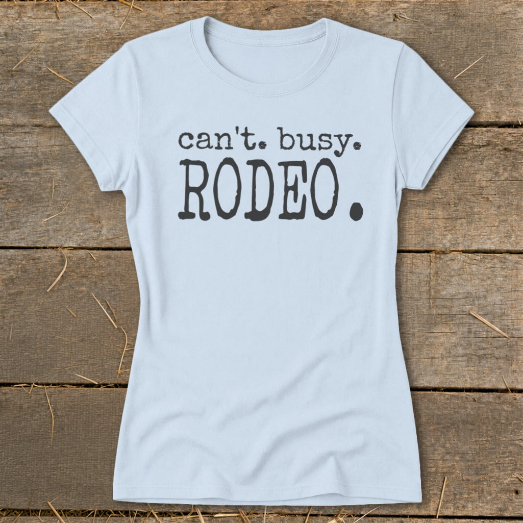 Light blue t-shirt with "can't. busy. RODEO." printed in black.