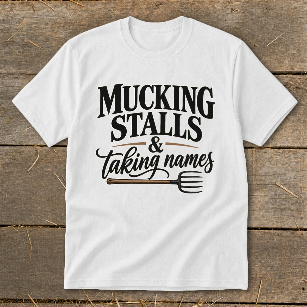 White t-shirt with "Mucking Stalls & Taking Names" text and a pitchfork graphic.