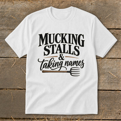 White t-shirt with "Mucking Stalls & Taking Names" text and a pitchfork graphic.
