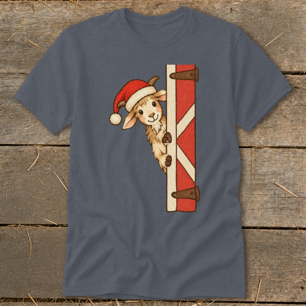 Cute goat in Santa hat peeking from behind a rustic red barn door.