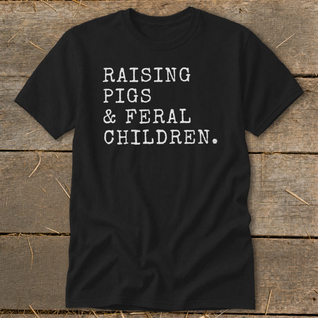 Black t-shirt with white text "RAISING PIGS & FERAL CHILDREN."