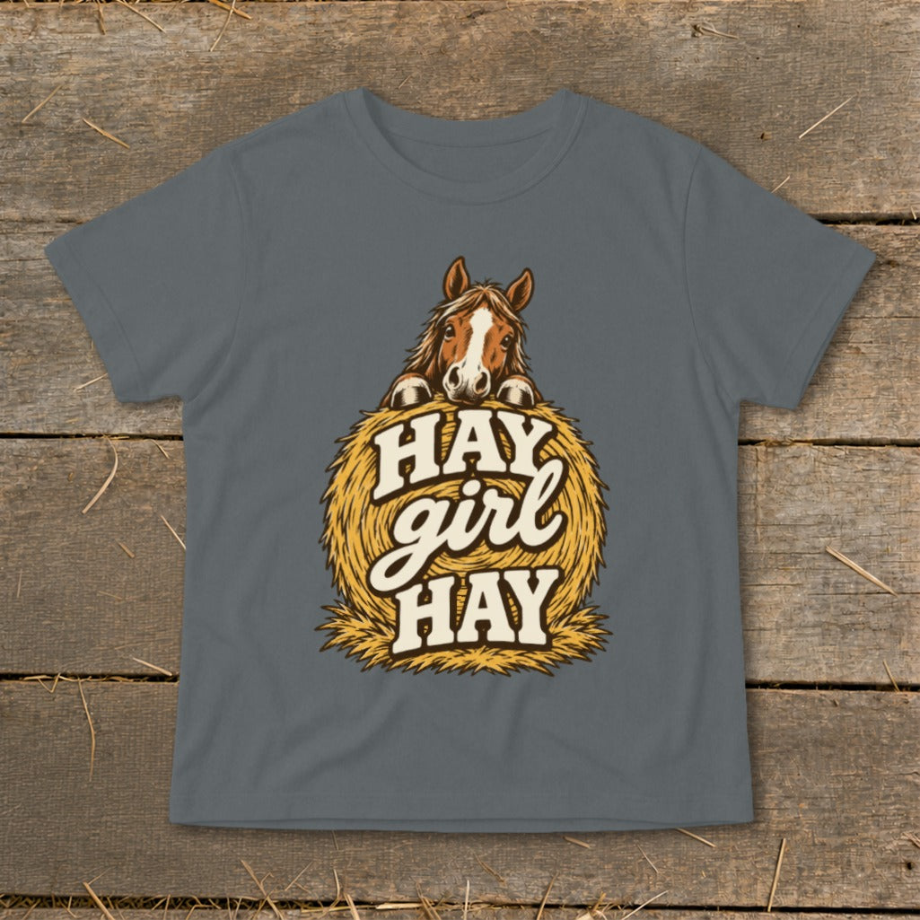 Horse peeking over hay bale with text "HAY girl HAY".