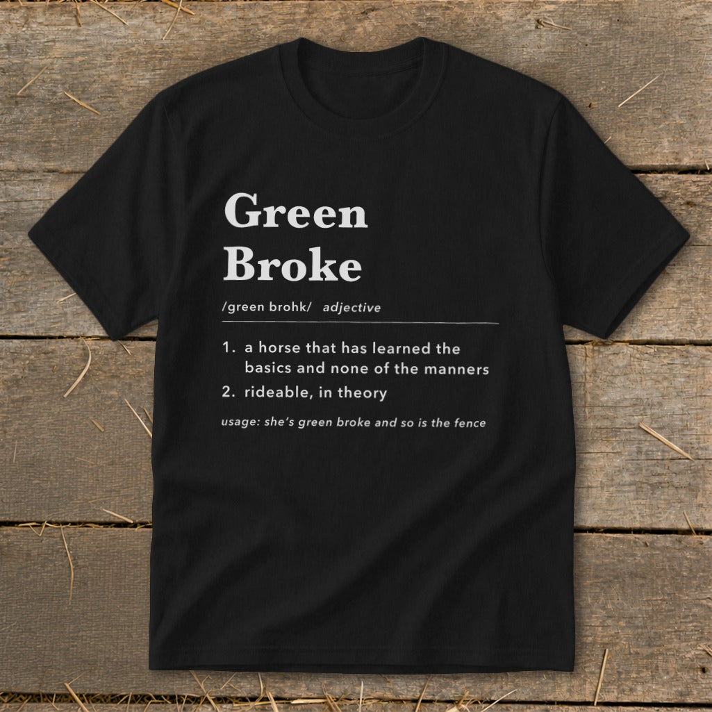 A black short-sleeve t-shirt with a humorous dictionary-style definition of green broke printed on the chest.