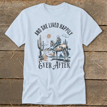 White t-shirt with desert graphic and text "And She Lived Happily Ever After."