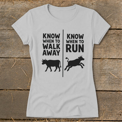 Light grey t-shirt with black text and cow graphics: "Know When to Walk Away" and "Know When to Run."