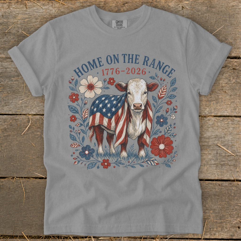 Cow wearing an American flag blanket surrounded by patriotic flowers, text "Home on the Range 1776-2026".