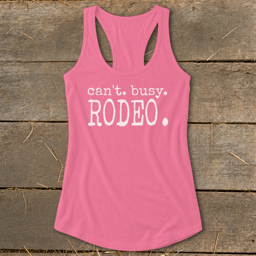 Pink racerback tank top with white text "can't. busy. RODEO."