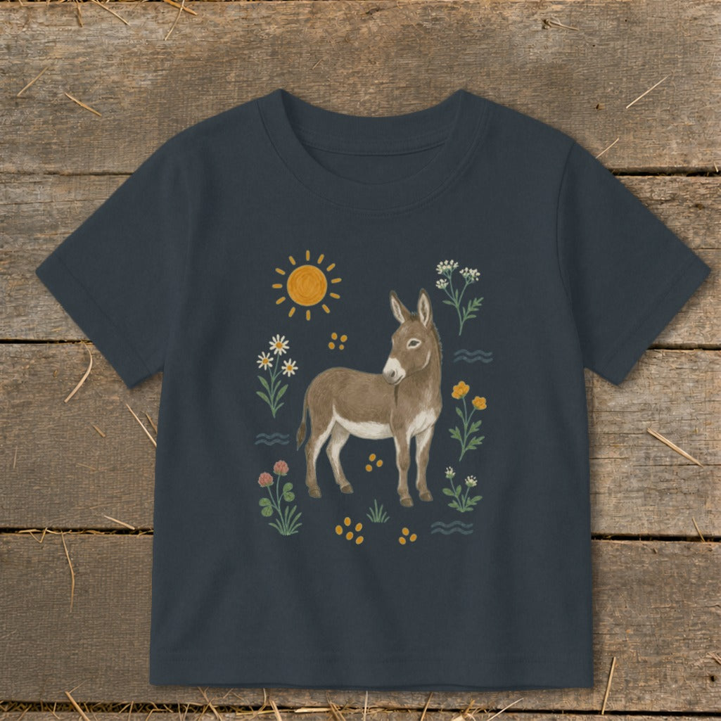 T-shirt with a donkey, sun, and wildflowers illustration.