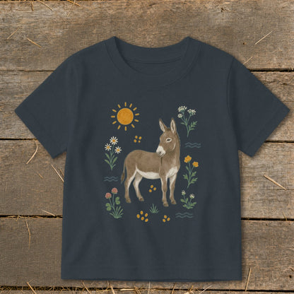 T-shirt with a donkey, sun, and wildflowers illustration.