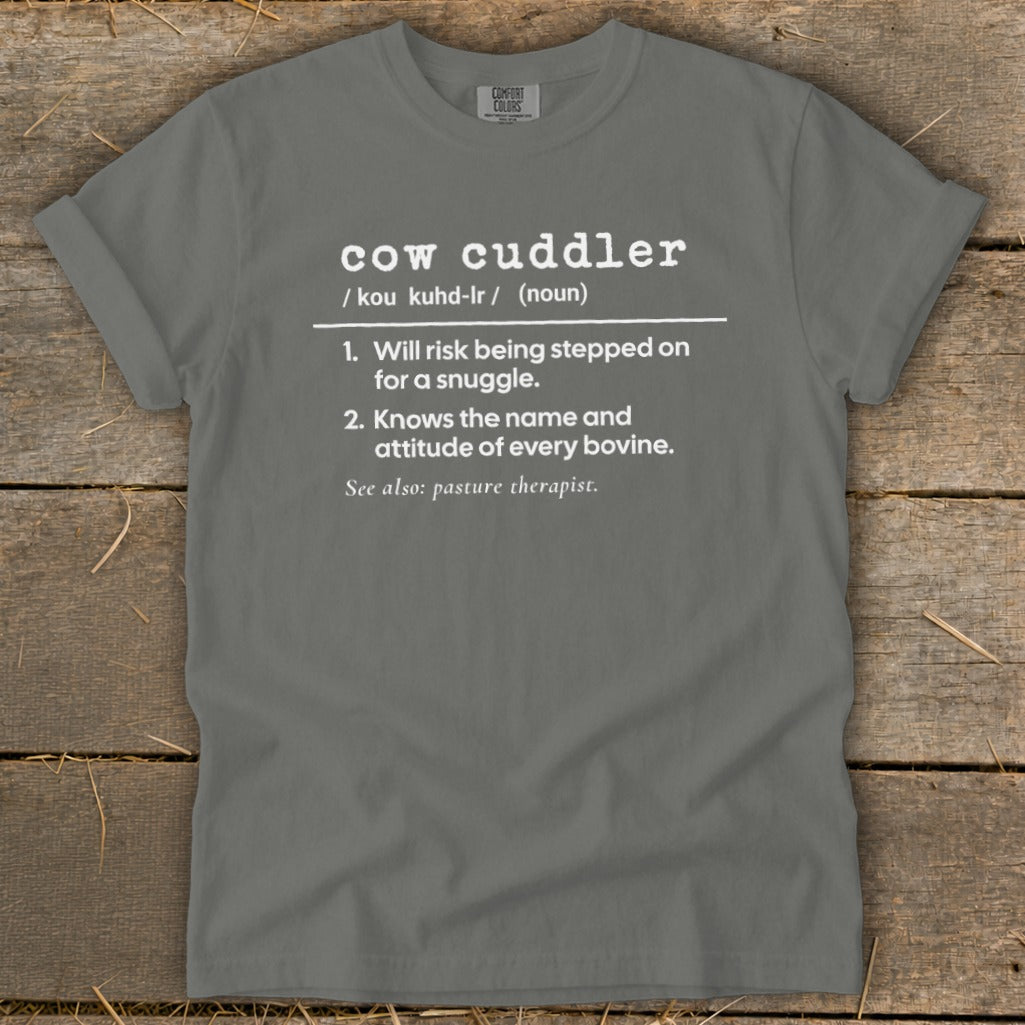Grey t-shirt with "cow cuddler" definition: risk being stepped on, knows bovine attitude.