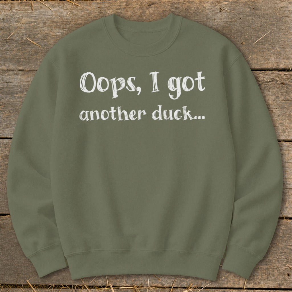 Olive green sweatshirt with white text "Oops, I got another duck..."