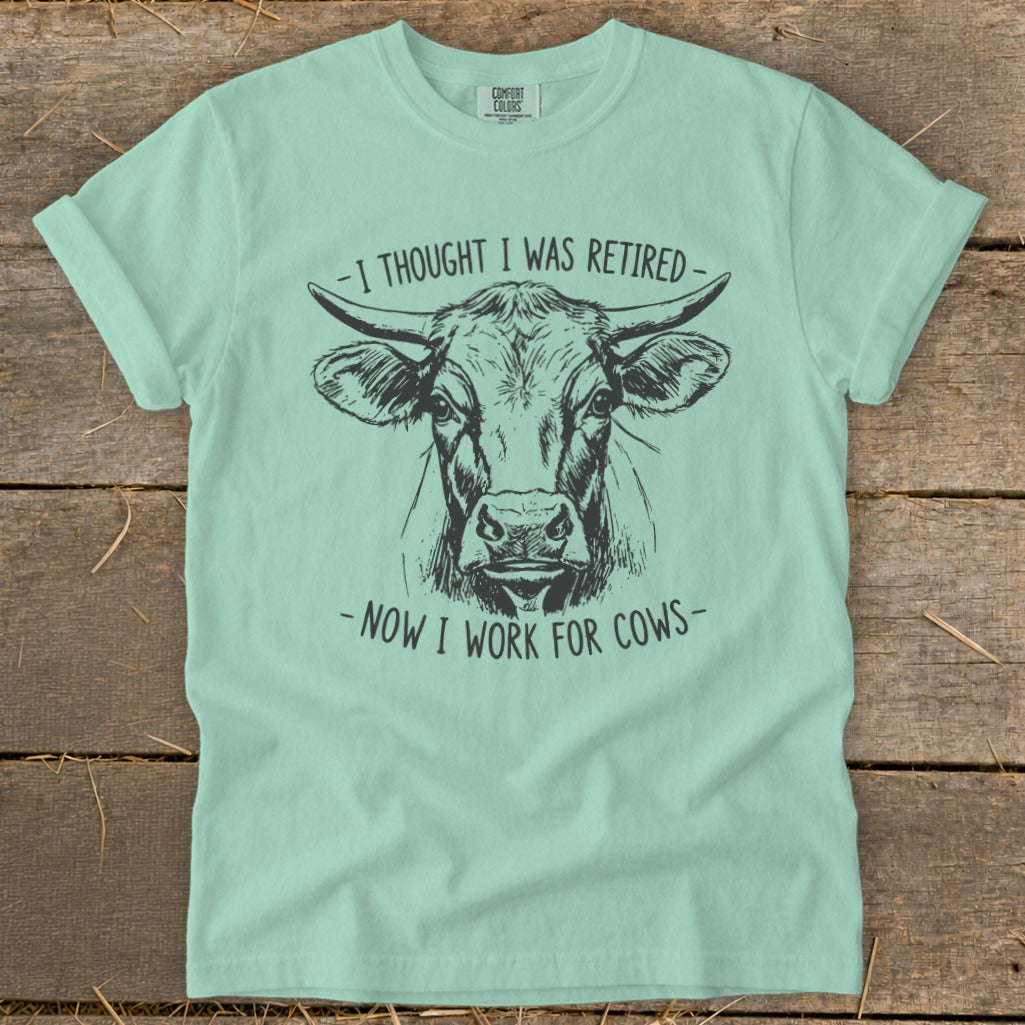 Mint t-shirt with a black line drawing of a cow's head and text.