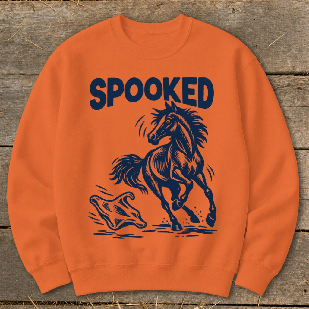 Orange sweatshirt with navy graphic of a startled horse and ghost, text reads "SPOOKED".