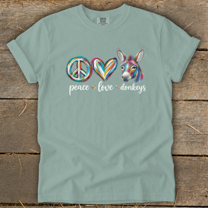 Green t-shirt with peace, heart, and donkey graphic and "peace love donkeys" text.
