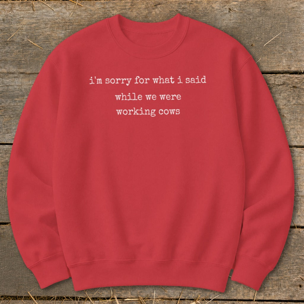 Red sweatshirt with white text "i'm sorry for what i said while we were working cows".