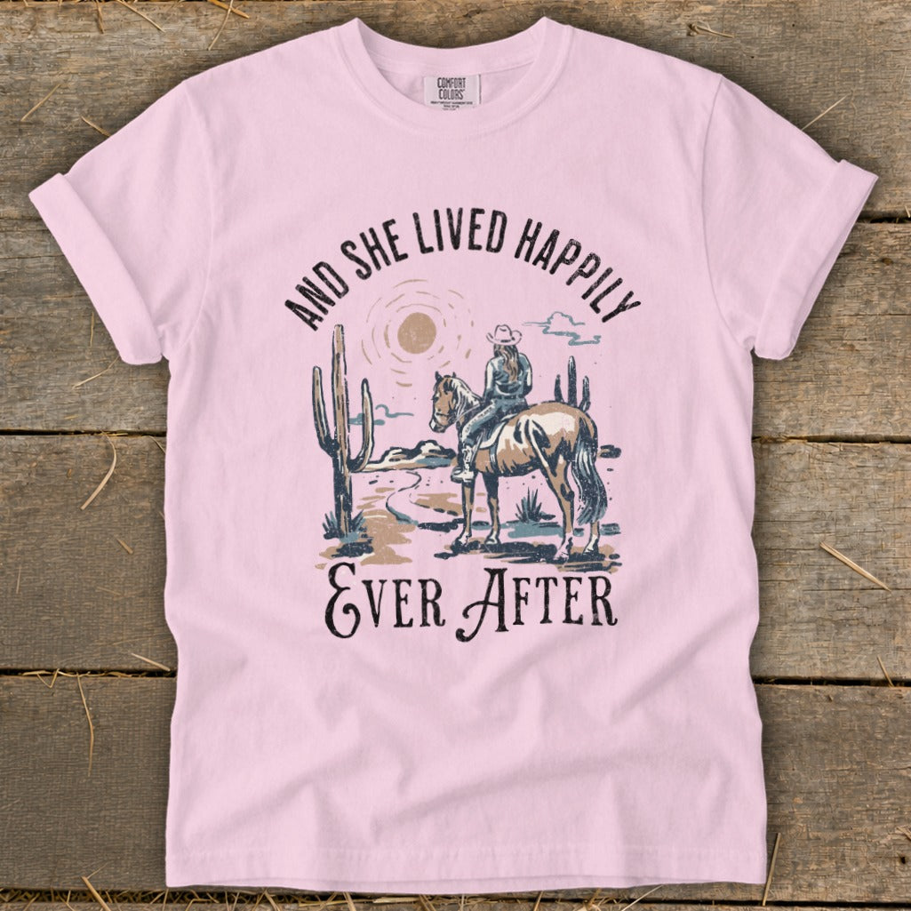 Pink t-shirt with desert graphic and text "And She Lived Happily Ever After".