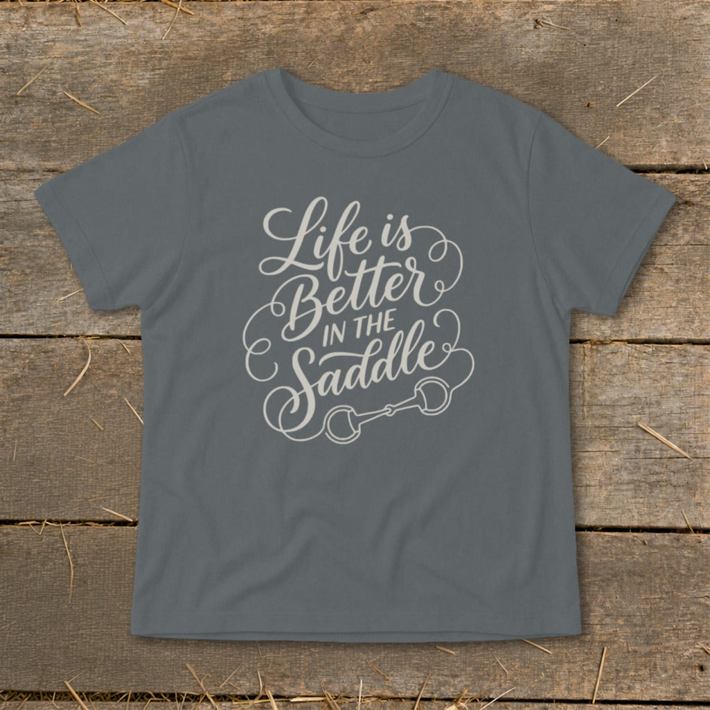 Grey t-shirt with white text "Life is Better In The Saddle" and a horse bit graphic.