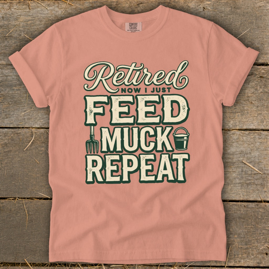 Peach t-shirt with "Retired Now I Just Feed Muck Repeat" text and farm graphics.