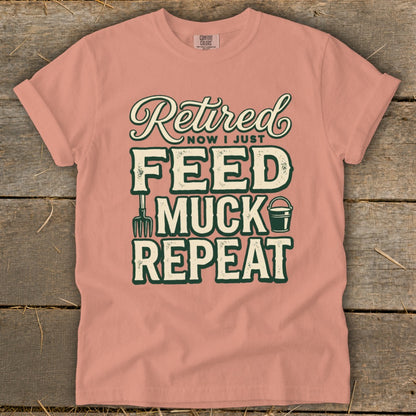 Peach t-shirt with "Retired Now I Just Feed Muck Repeat" text and farm graphics.