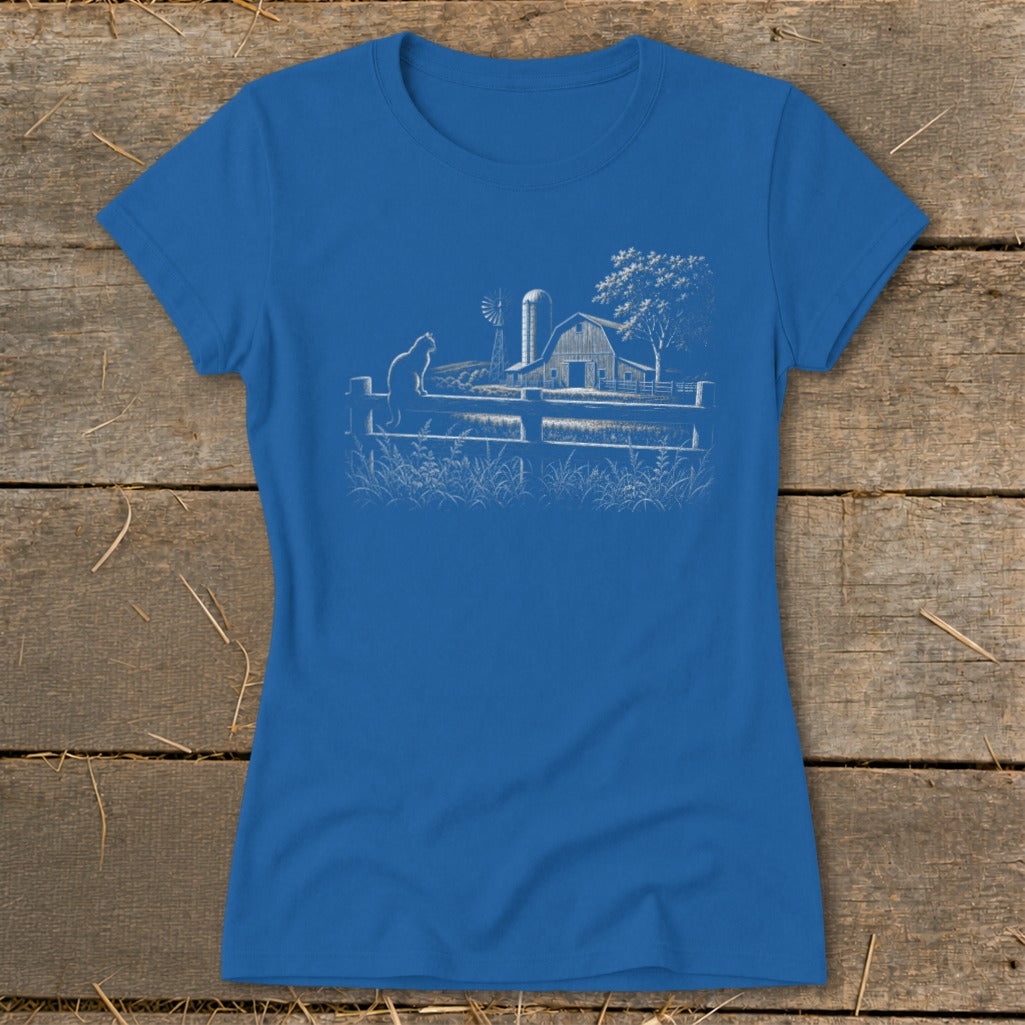Blue t-shirt with white line drawing of a cat, barn, windmill, and tree.