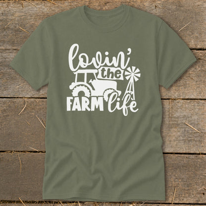 Green t-shirt with white graphic reading "lovin' the FARM life" with tractor and windmill.