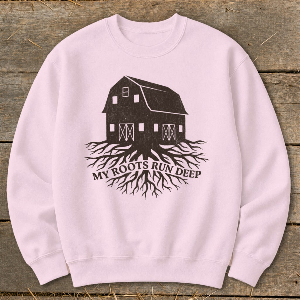 Pink sweatshirt with a graphic of a barn with roots and text "MY ROOTS RUN DEEP".