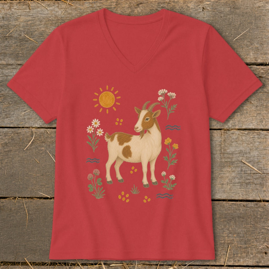 Red t-shirt with a brown and white goat illustration surrounded by flowers and a sun.