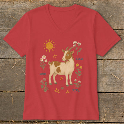 Red t-shirt with a brown and white goat illustration surrounded by flowers and a sun.