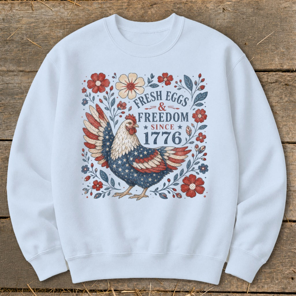 Chicken with American flag wings surrounded by flowers and text "Fresh Eggs & Freedom Since 1776".