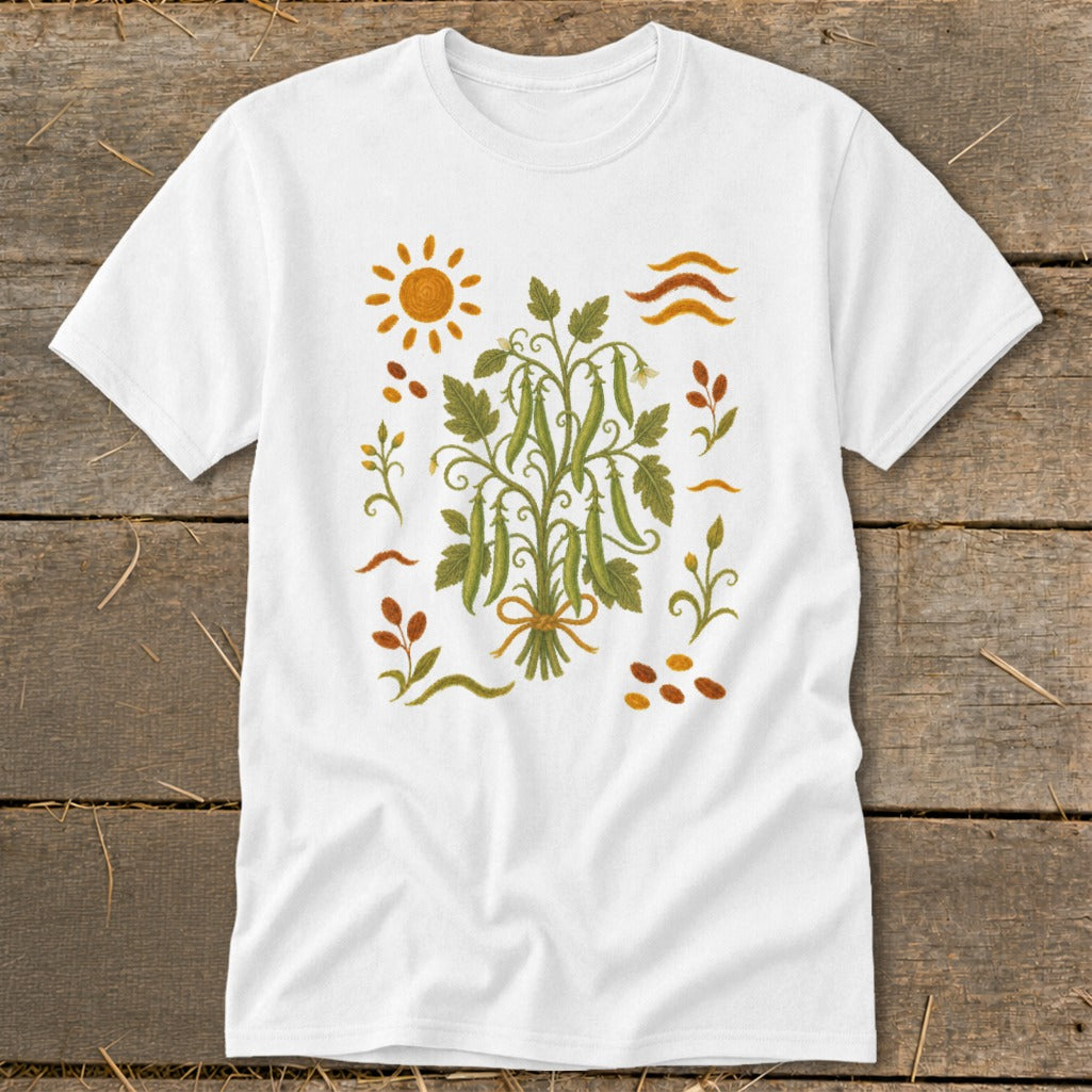 White t-shirt with a folk art illustration of a pea plant bunch and sun.