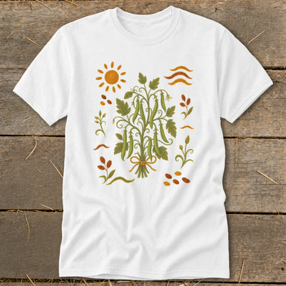 White t-shirt with a folk art illustration of a pea plant bunch and sun.