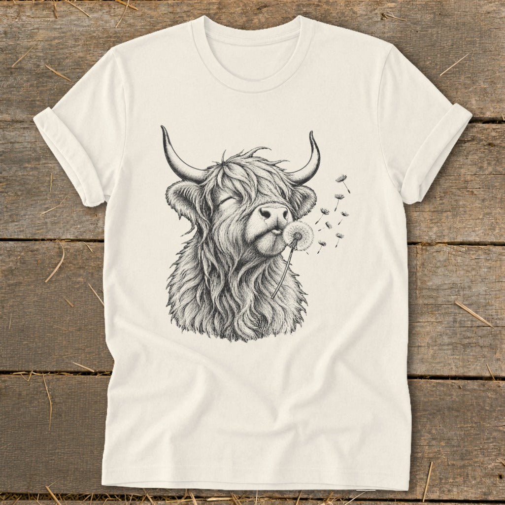 T-shirt with sketch of Highland cow blowing dandelion seeds.