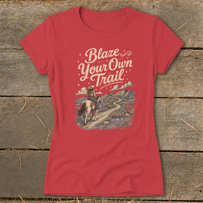 Red t-shirt with "Blaze Your Own Trail" text and a person riding a horse on a desert landscape.